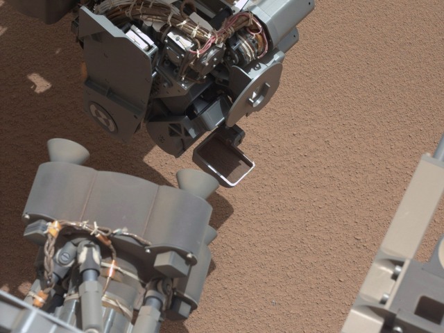 Curiosity Rover takes a scoop of Mars. (Photo by NASA/JPL-Caltech/MSSS via Getty Images)